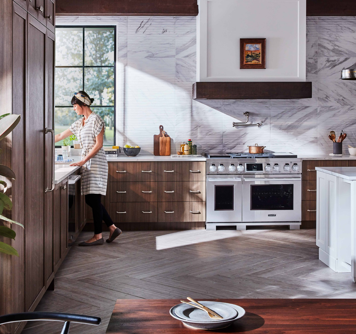 True Partner Rewards Program Woman at sink in Signature Kitchen Suite kitchen